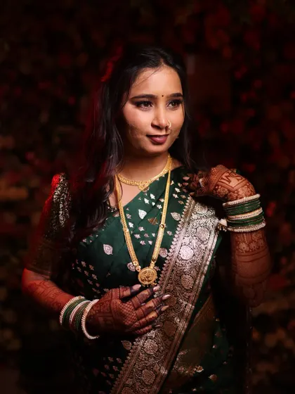 A close-up portrait highlighting the bride's radiant skin and soft, defined eyes. This is a timeless look for any Maharashtrian bride.