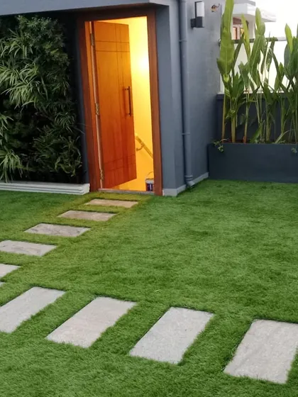 This is another view of the rooftop terrace project, highlighting how the artificial grass, pavers, and planters work together. The design creates distinct zones for walking and relaxing, all while maintaining a cohesive, modern aesthetic.