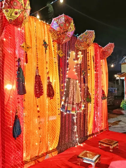 This is a traditional Rajasthani-themed baby shower decoration. I used vibrant bandhani drapes, puppets (kathputli), and decorative umbrellas to create a colorful and authentic backdrop for the ceremony.