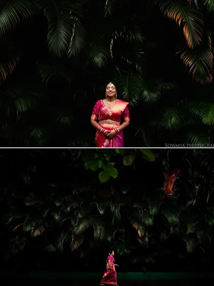 A dramatic composition showing the bride against a dark, leafy background. The contrast makes her pink saree pop, creating a visually stunning portrait.