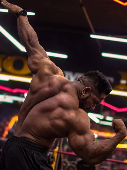 Building a championship-winning back requires hitting it from all angles. This iconic pose shows the width and thickness that we develop through countless hours of pulling and rowing.