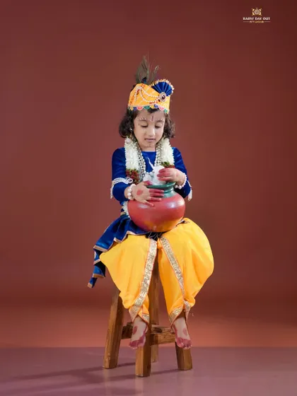 A little Krishna enjoying a pot of 'butter'. We use safe and fun props to make our themed shoots interactive.