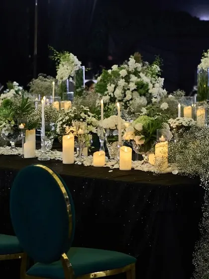 A long table setting for a Sangeet, with a dense runner of baby's breath and candles, creating a dreamy, cloud-like effect.