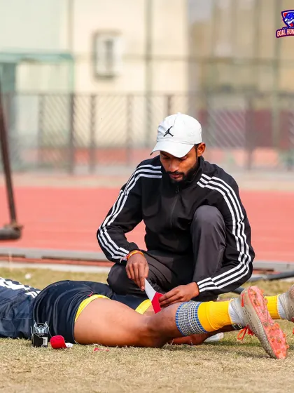 A coach tending to a player's injury on the sidelines. We take care of our own.