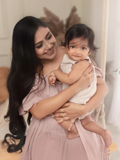 A beautiful mother and child portrait on our in-studio swing. The soft pastel colors of their outfits and the gentle interaction create a dreamy and loving image.