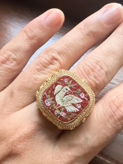 A micromosaic ring featuring two doves, symbolizing love and partnership. Handcrafted in 18k gold with a detailed filigree band, this piece is a perfect heirloom to signify a special connection.