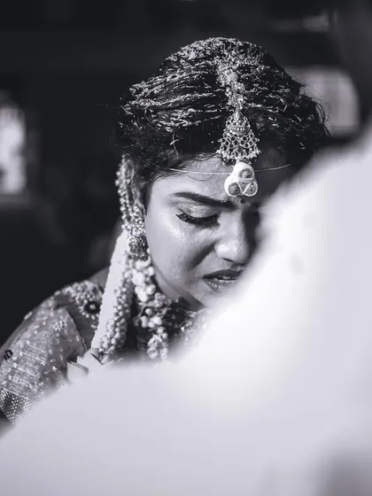 An emotional black and white portrait of the bride, capturing a moment of deep contemplation during the ceremony.
