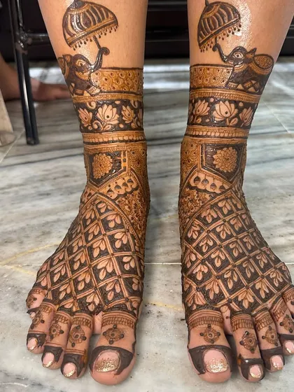 A grand design for bridal feet, with elephants holding umbrellas and a full coverage geometric pattern.