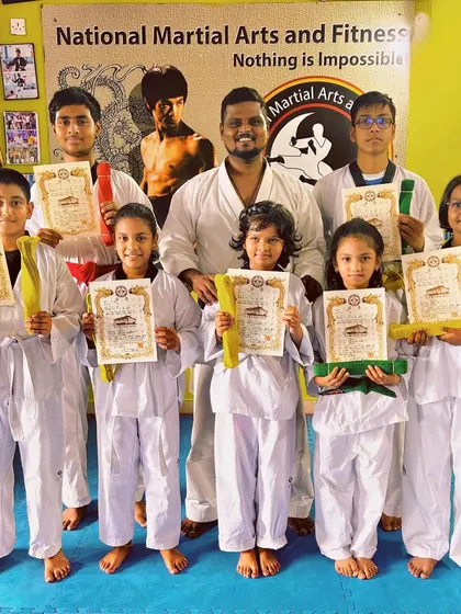 A group of our Taekwondo students proudly displaying their new belts and certificates. This photo captures the sense of collective achievement after a successful grading.