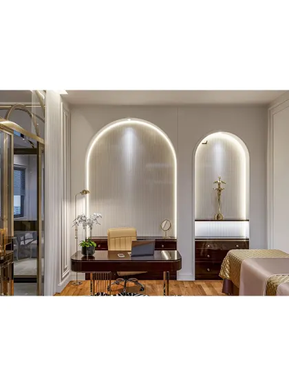 An elegant home office or study area with arched wall niches and integrated lighting. The dark wood desk and classic decor create a timeless and sophisticated workspace.