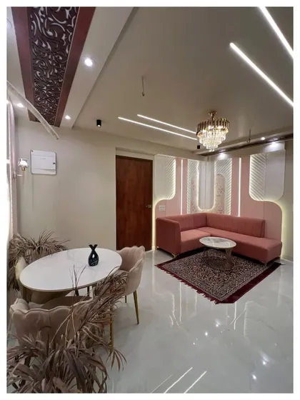 A compact living and dining area designed for maximum style. The curved pink sofa and round dining table soften the lines of the room, while the textured wall panels with ambient lighting add a touch of luxury. This project demonstrates our ability to create beautiful, functional spaces even in smaller footprints.