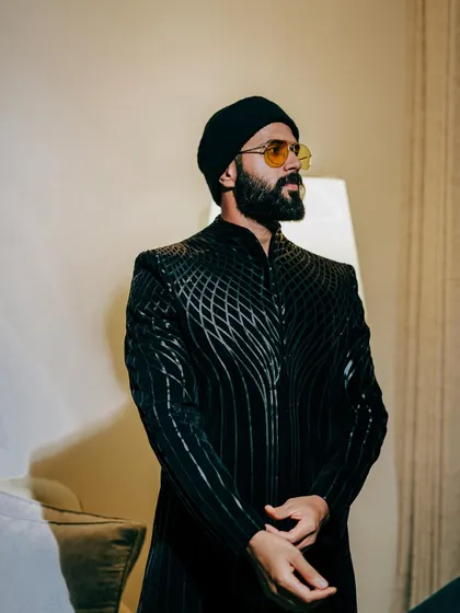 This shot shows the full silhouette of Vijay's modern bandhgala. Paired with a simple beanie, the look is an unexpected mix of traditional and street style.