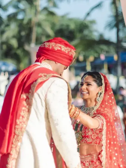 The first look at the mandap. The bride's radiant smile as she sees her groom captures the magic of this long-awaited moment at their beautiful beach wedding.