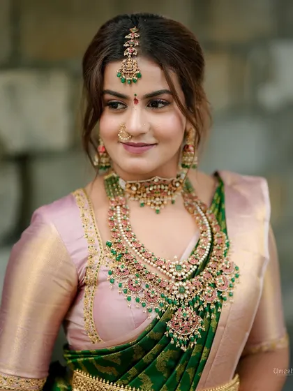 Another beautiful portrait, showcasing the maang tikka and nose ring that complete her festive look.