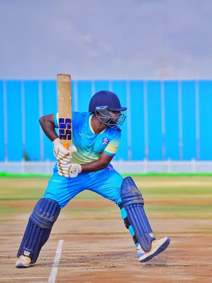 A full-length shot of Coach Sandeep in his batting stance, demonstrating the perfect form we teach our students.