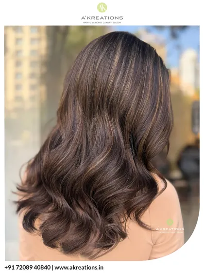 A side view of our dazzling warm brown highlights, showing how the color is seamlessly blended and styled into flowing waves.