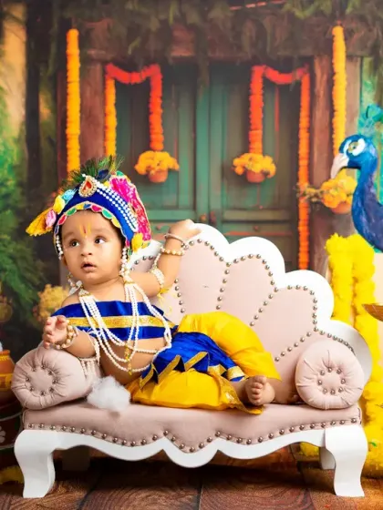 Another regal pose from our little Krishna, looking thoughtfully to the side. The variety of poses ensures a diverse gallery of images for your family.