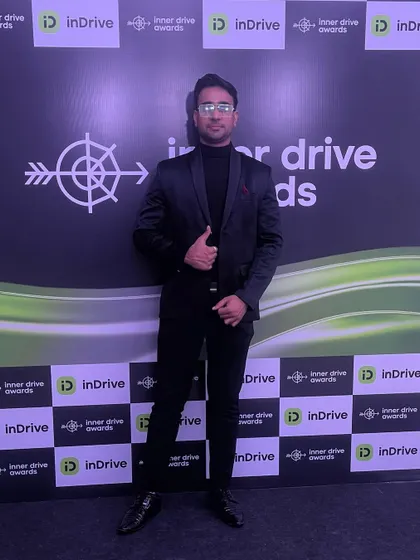 At the inDrive "Inner Drive Awards" photo wall. I enjoy being part of the celebration with the employees and management.