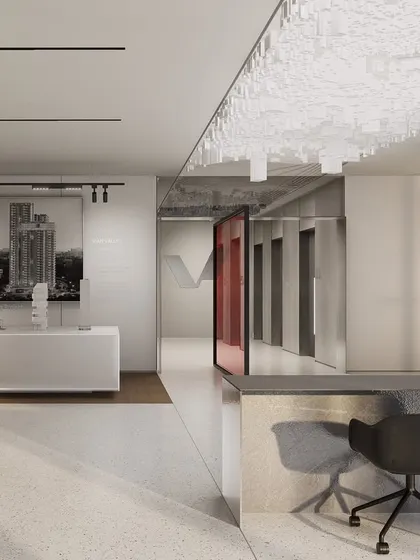 The central circulation spine of the Vian Office, featuring a clean, white reception desk and gallery wall that tells the company's story. This corridor is designed to be the backbone of the office, encouraging movement and spontaneous interaction.