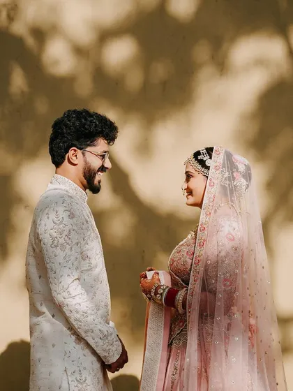A stylish portrait of the couple, their smiles and loving gaze captured against a wall with beautiful shadow play.