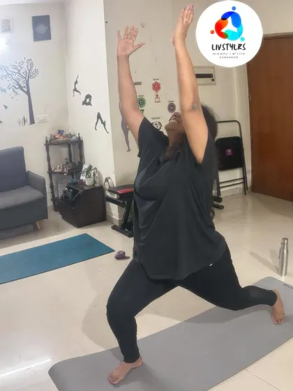 A client joyfully holds a high lunge pose, demonstrating strength, balance, and a positive mind-body connection.