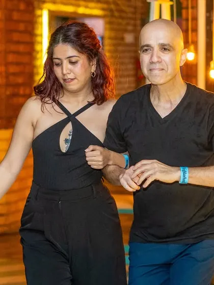 A focused and connected pair moving together seamlessly. This showcases the beautiful partnership in Latin dance.