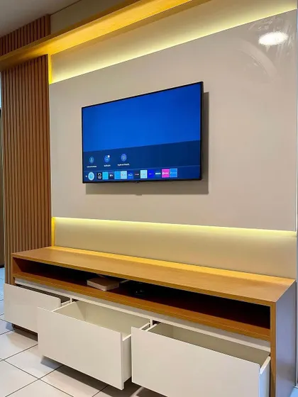 The drawers of the simple TV unit are pulled out to show the storage capacity.