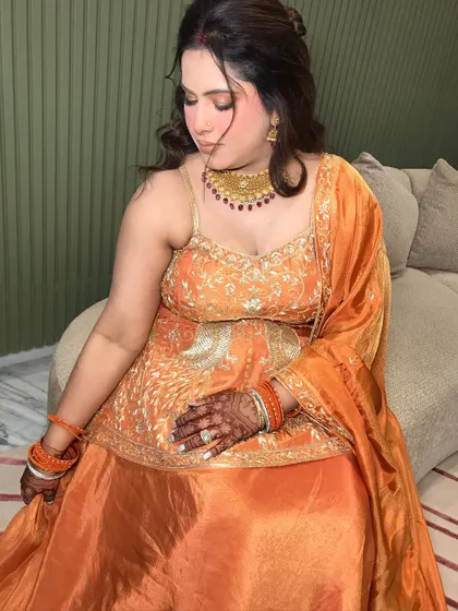 A serene portrait, her hands showing her mehndi and rings.