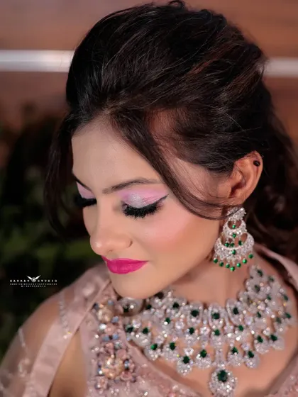 A beautiful close-up focusing on the bride's makeup. The bright pink lipstick and soft pink eyeshadow are perfectly captured, showcasing a bold and modern look.