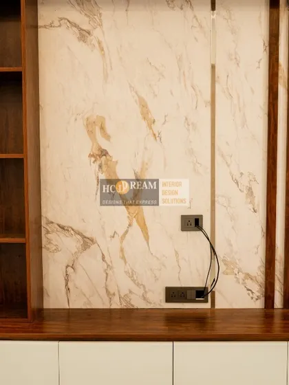 A close-up of the TV unit in the Kolkata project, showcasing the beautiful marble-finish panel and wooden slats that add texture and visual interest.