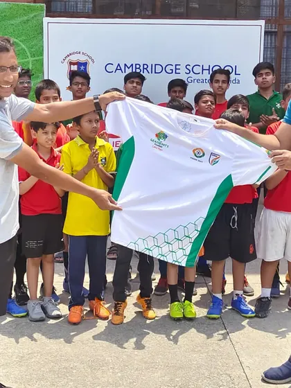 Another shot of the jersey presentation at the AFC Grassroots Football Day event, held in partnership with Cambridge School.
