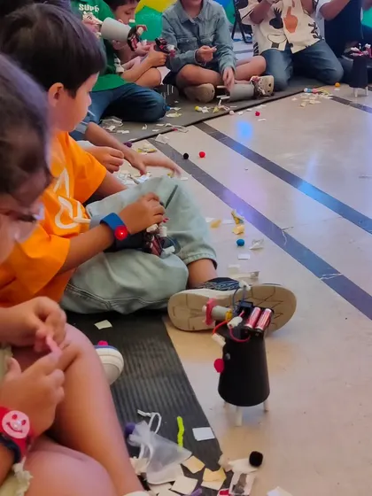 Concentration and creativity go hand in hand. This student is carefully adding the finishing touches to their DIY robot during a fun-filled birthday party workshop.