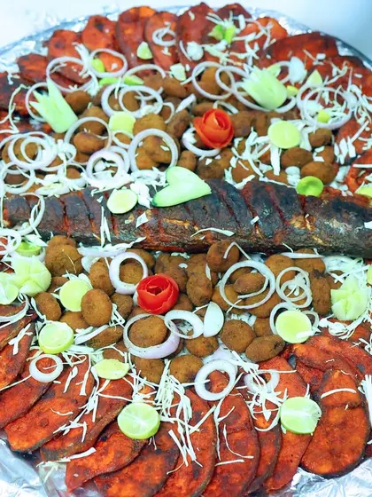 A feast for the eyes and the palate. This platter showcases a variety of our seafood specialities, including whole fried fish and prawn cutlets, all prepared fresh for the event.