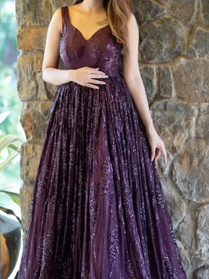 A full view of our pleated purple sequin gown. This is a great rental option for cocktail parties or wedding receptions.