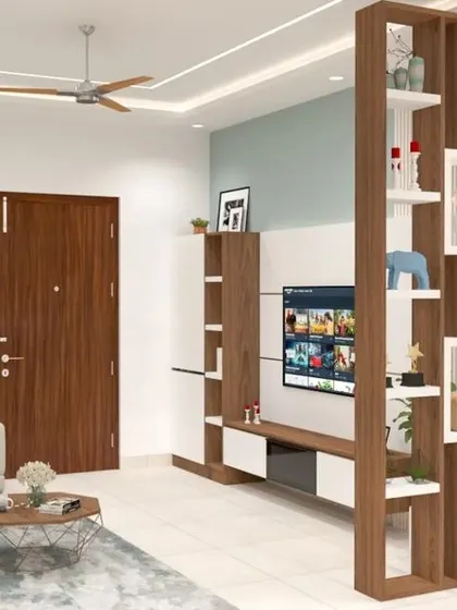 This design uses a wooden rafter partition to cleverly separate the living room from the entryway. The partition adds a visual feature with built-in shelving while maintaining an open and connected feel.
