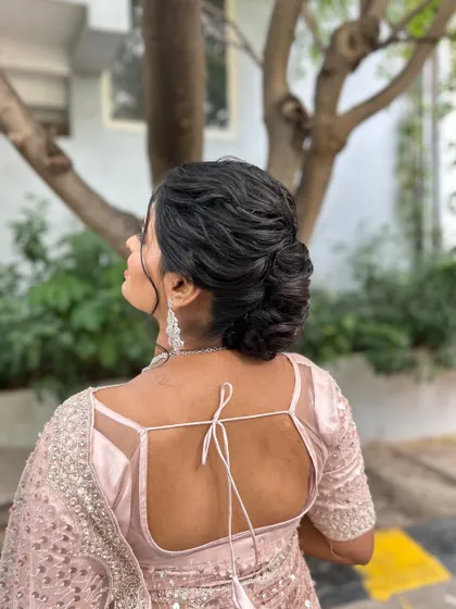 A beautiful profile of the textured low bun, a perfect hairstyle for a reception or engagement party.