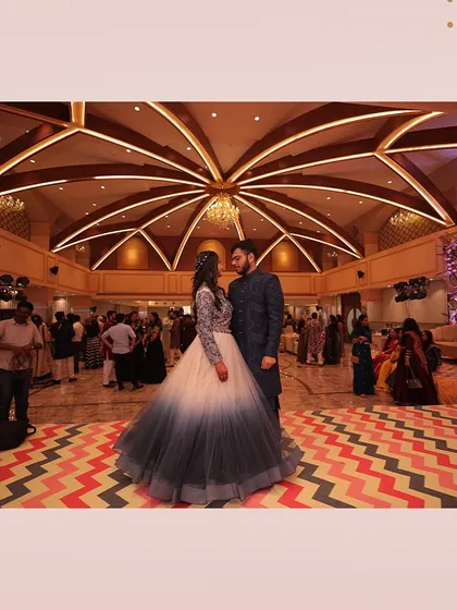 The sangeet night is in full swing at our spacious banquet hall. The unique chevron-patterned dance floor and grand ceiling create a perfect party atmosphere.