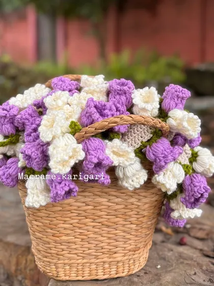 Our crochet blanket bouquet displayed in a basket. It’s a beautiful decor piece for a nursery before it's used as a cozy blanket for the baby.