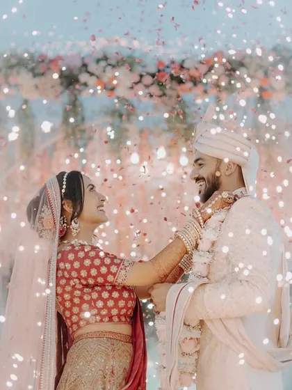A magical Varmala moment, with the couple surrounded by a shower of sparkles from cold pyros, creating a dreamy, romantic scene.