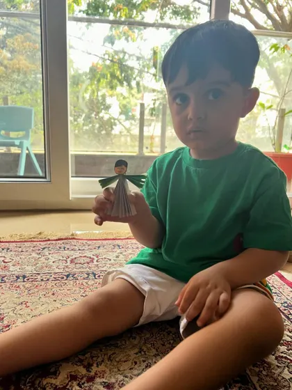 This little man is proudly holding the paper fairy he crafted. Our art sessions are for everyone.