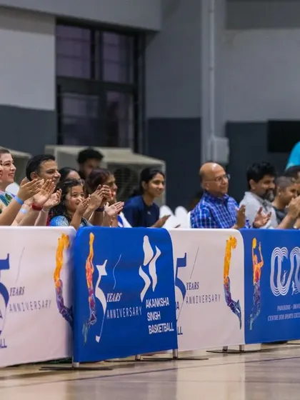 The crowd, including family and senior players, cheers on the next generation. We've built a supportive community that uplifts athletes at every level.