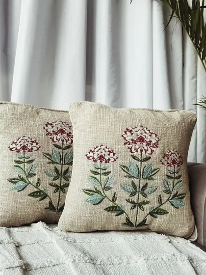 This cushion cover features a classic Mughal-inspired floral embroidery. The intricate design adds a touch of heritage and sophistication.
