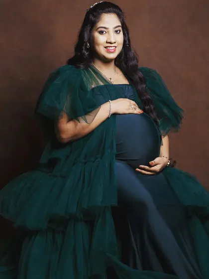 A seated portrait in the emerald green tulle gown, showing how the layers of tulle create a beautiful, full look even while sitting.