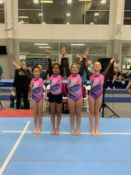 Our Xcel Silver team posing together at the Silver sectionals in Spring, Texas, marking the end of a great season.