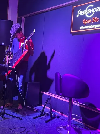 A musician performs on the keytar, showcasing the diverse range of instruments and styles you'll find at our open mic events.