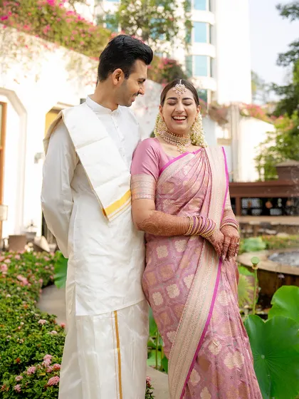 Laughter and joy are what make a wedding memorable. Here, the bride's perfectly draped pastel silk saree complements her happy expression, creating a picture of pure elegance and happiness.