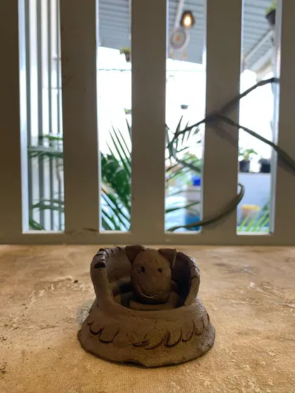 A tiny turtle peeking out of its shell. This small, hand-built sculpture is full of character.