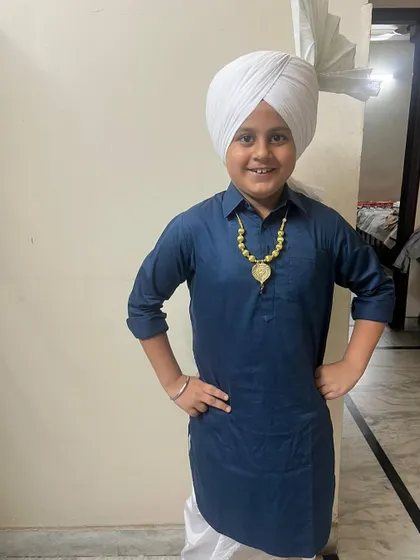 One of our proud students dressed in a traditional Punjabi kurta pajama and turban, ready for his school dance competition. We help our students with costumes and presentation too.