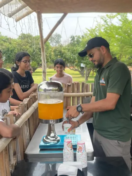 An instructor serves refreshing drinks to the campers. We ensure everyone stays hydrated and energized throughout the day's activities.