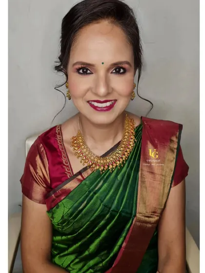Anushree looking warm and beautiful for a family event. This look features a classic red lip and soft brown eyeshadow, perfect for her green and red silk saree.